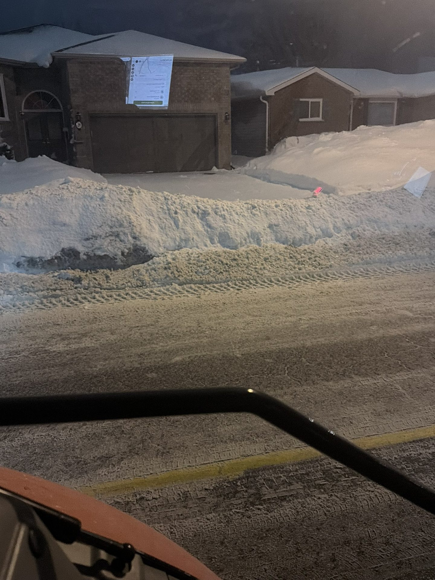Snowforce crew clearing snow from a home driveway